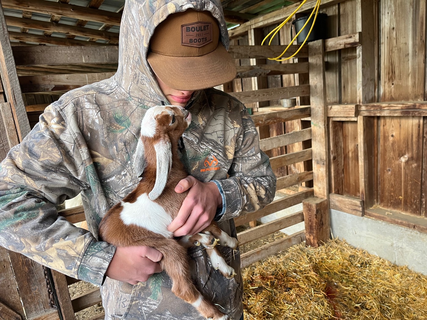 One of the kids holding a goat kid