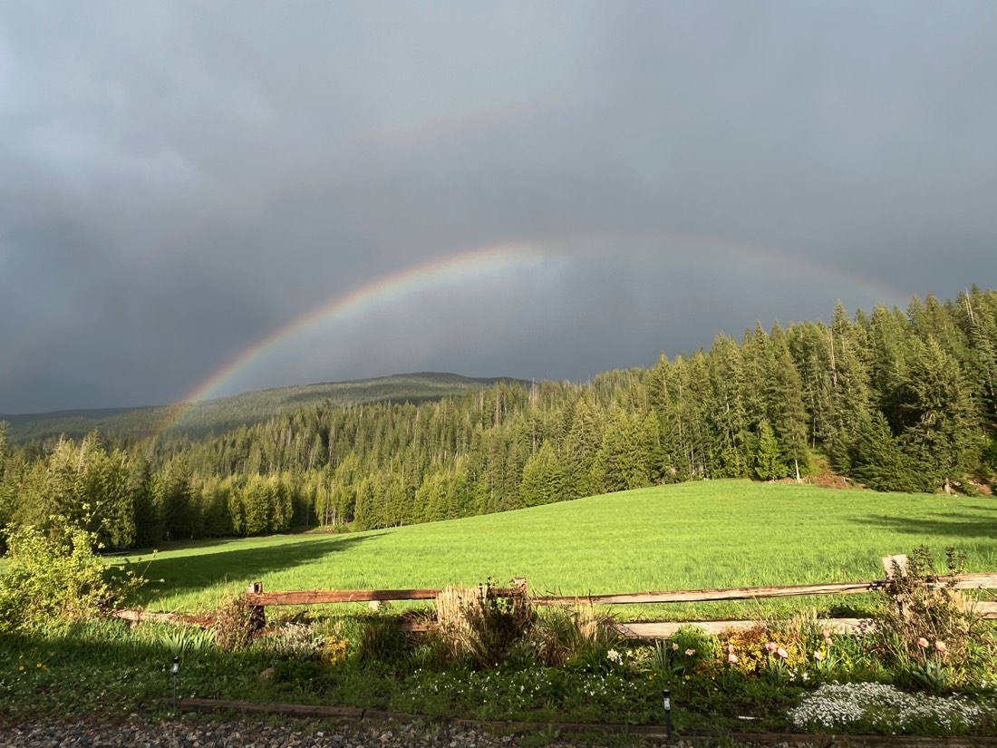 A rainbow arcing over the green spring fields